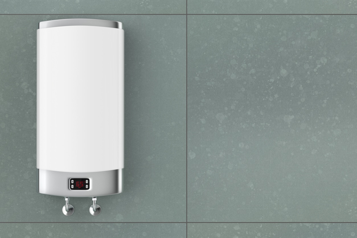A tankless water heater mounted to a green tile bathroom wall. SAC Mechanical installs top-rated Navien water heaters.